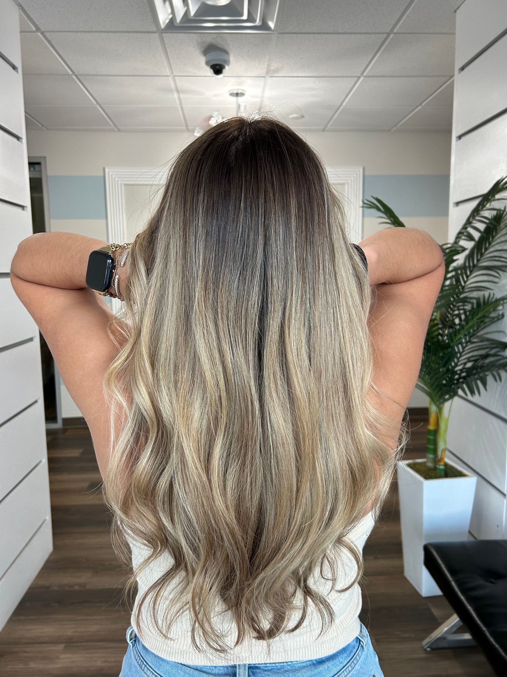A woman with long blonde hair is wearing a leopard print top.