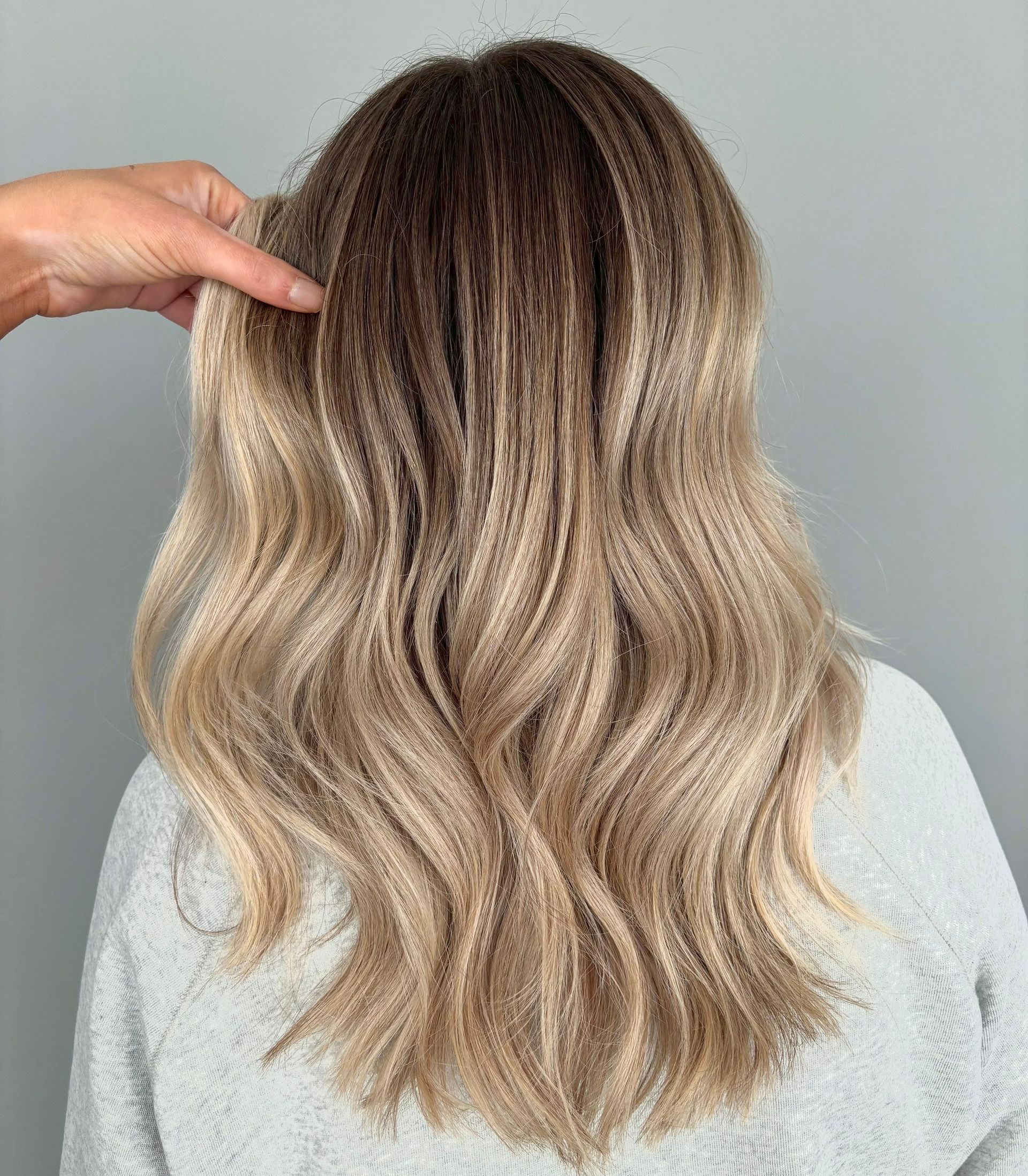A group of women standing next to each other holding hair dryers.