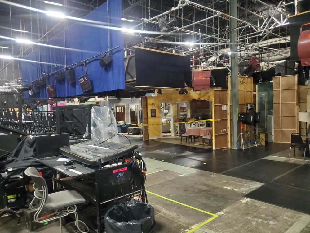 A large warehouse filled with lots of equipment and a trash can