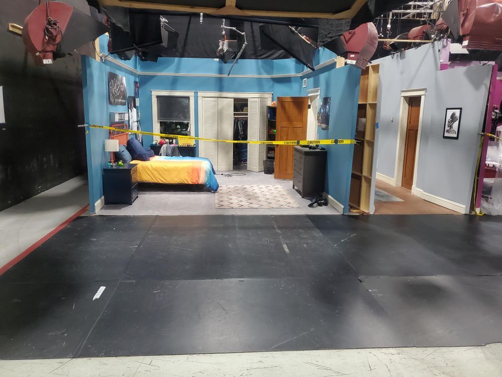 A bedroom with a bed and a yellow tape around it