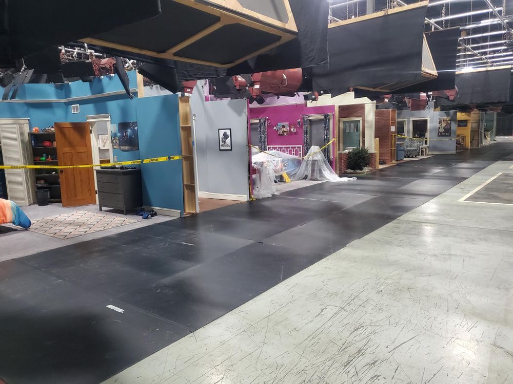 A large empty room with a lot of furniture and a yellow tape