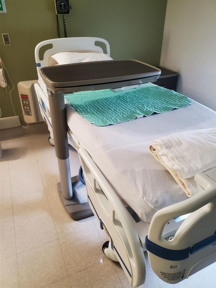 A hospital bed with a table on top of it