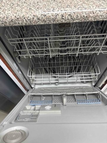 The inside of a dishwasher with the door open