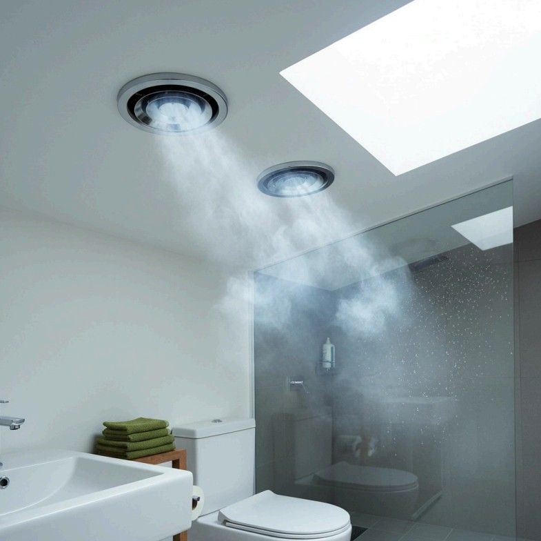 Bathroom with two ceiling vents emitting steam; a sink, toilet, and glass shower wall are visible.