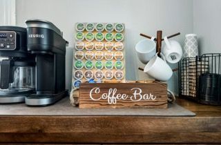 Coffee bar setup with Keurig machine, K-cups, mugs, and a 