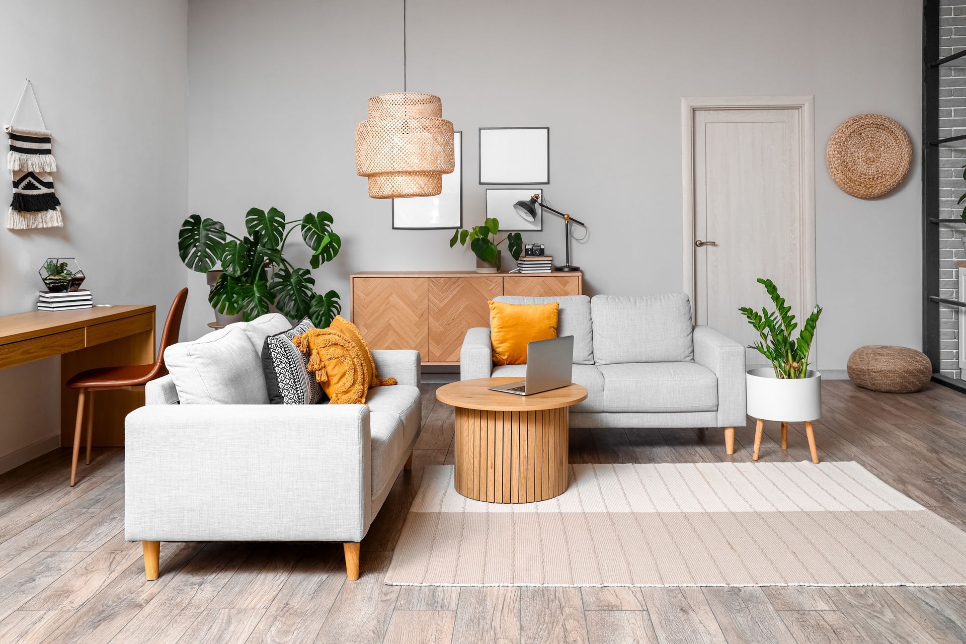 A living room filled with furniture and a laptop on a table