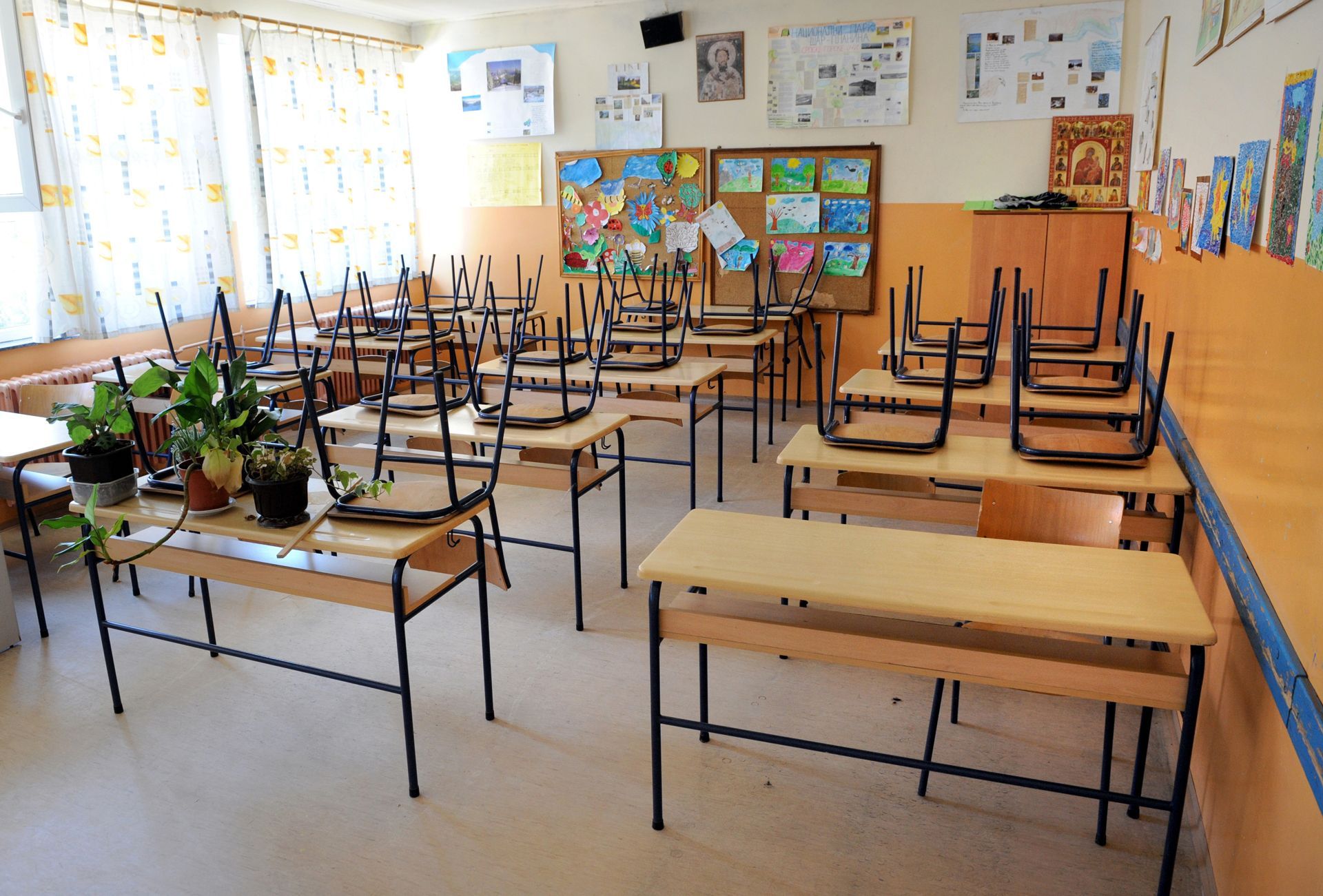 An empty classroom with tables and chairs upside down