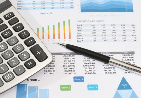 Refinance your home with our help. Calculator, pen, papers with charts