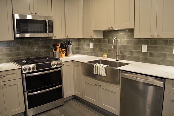 Neutral colored kitchen remodel with silver appliances built by WS Design & Build