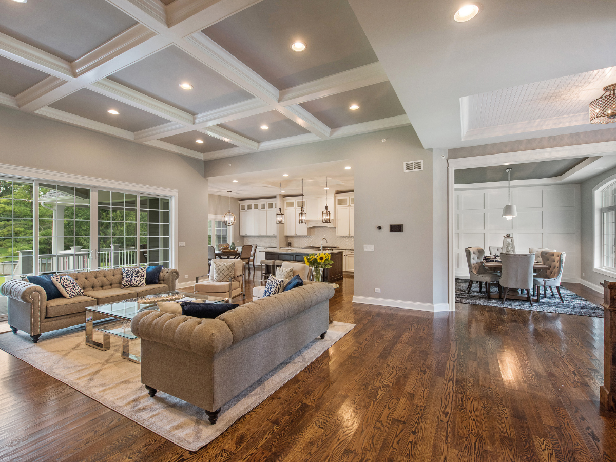 A living room filled with furniture and a coffered ceiling.