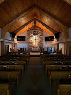 Our beautiful sanctuary lit by the cross. 