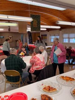 Folks enjoying pizza at the kids pizza party.