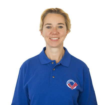 A woman wearing a blue polo shirt with a heart on it. San Juan Auto Smog = woman owned.