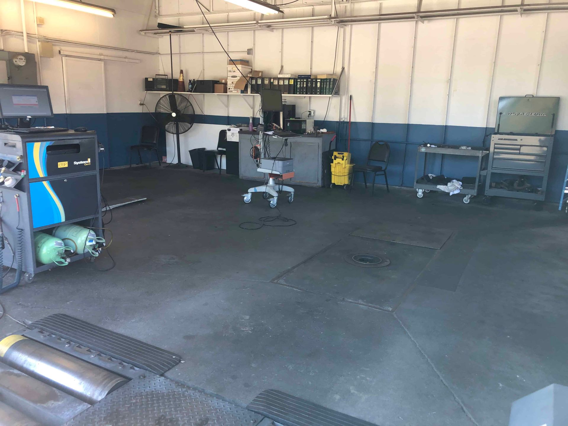 A garage with a lot of tools and a chair in it