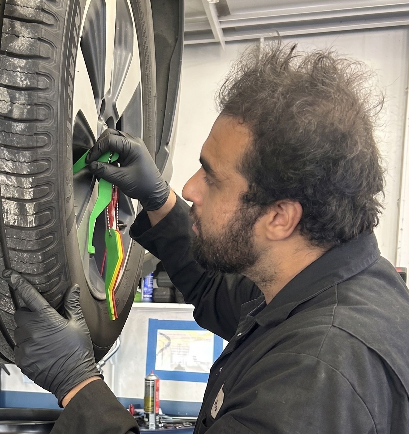 Checking tire tread depth as part of a complete brake and safety inspection at San Juan Auto Smog