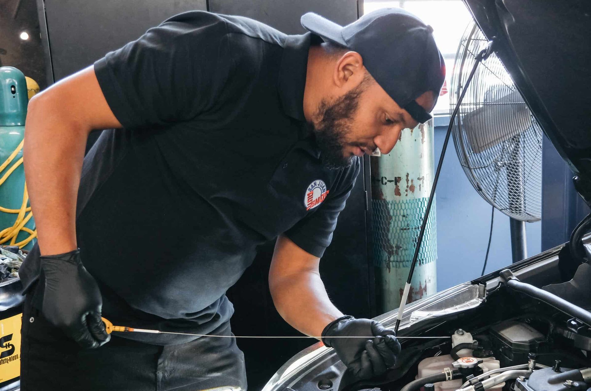Checking engine fluids during routine maintenance to keep your vehicle running reliably