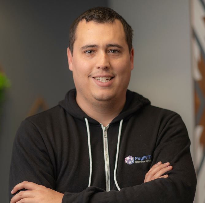 A man wearing a black hoodie with the word profit on it
