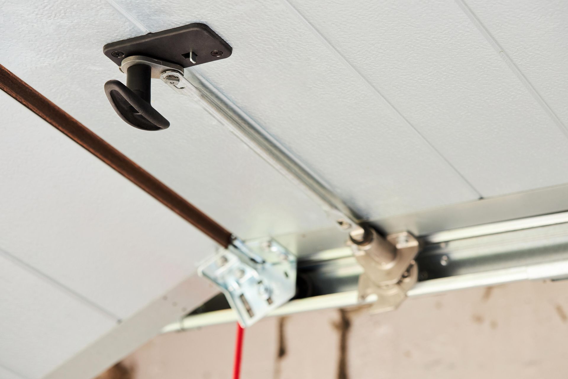 Garage door opener mechanism, including a metal arm, track, and release handle. Garage door opener mechanism, including a metal arm, track, and release handle.