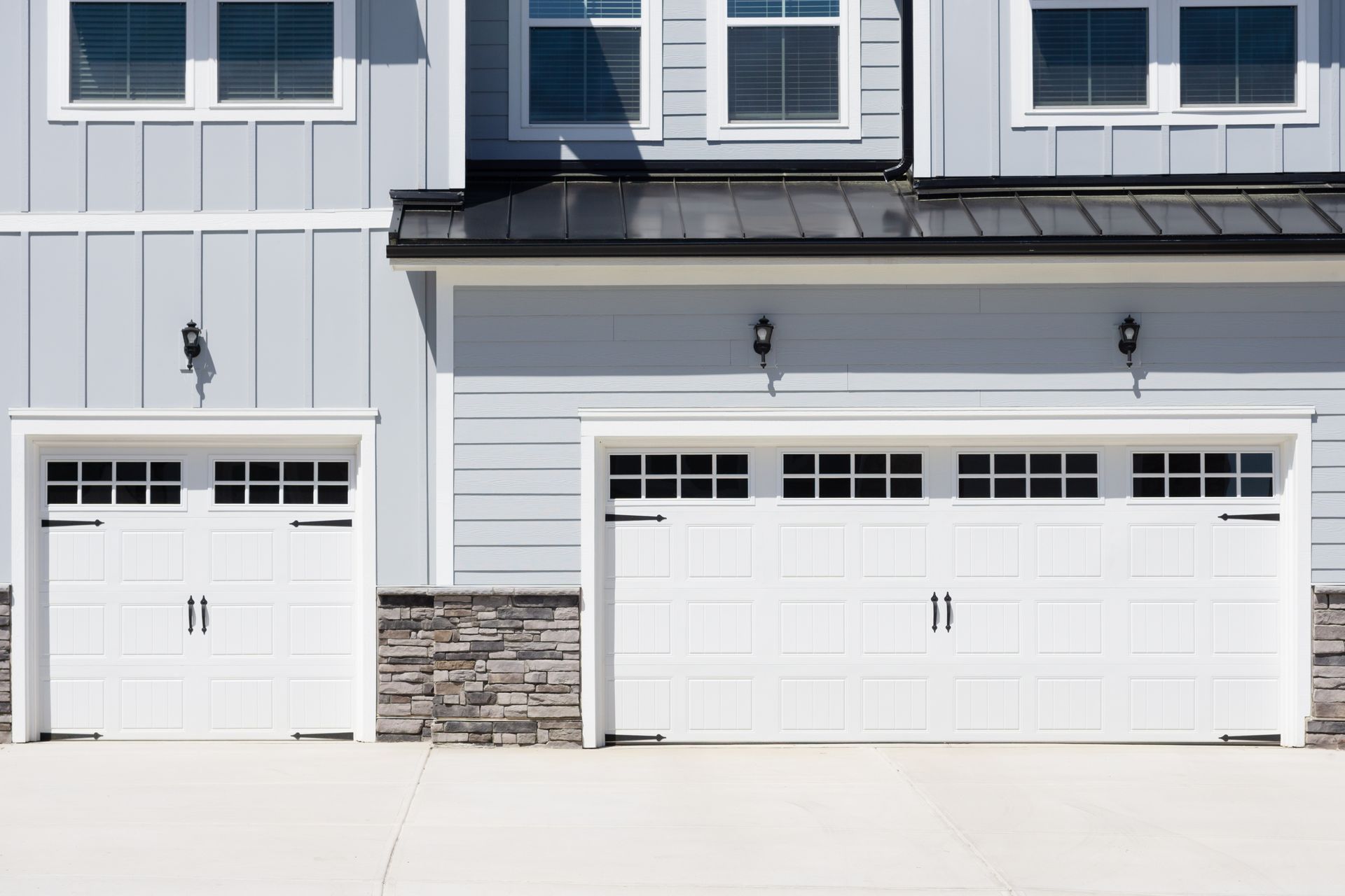 White residential garage door with windows. White residential garage door with windows.