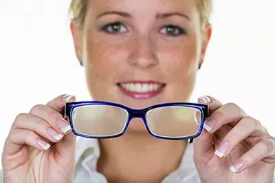 lady holding up a pair of frames