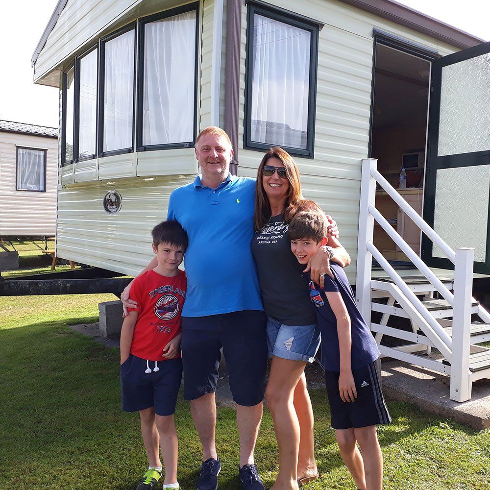 Happy Family outside of Static Caravan in Pennymoor Caravan and Camping Park