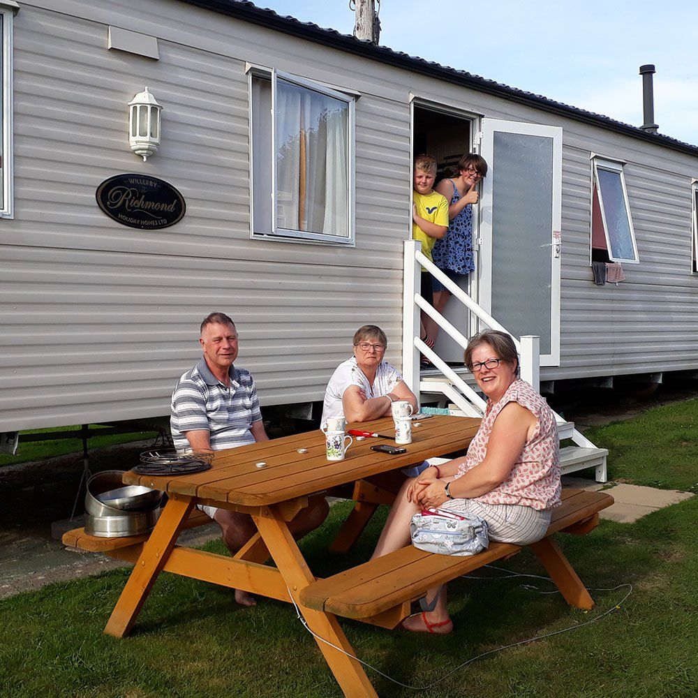 Happy family staying at Pennymoor Caravan and Camping Site