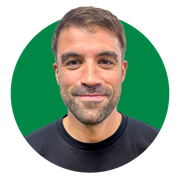 A man with a beard is smiling in a green circle.