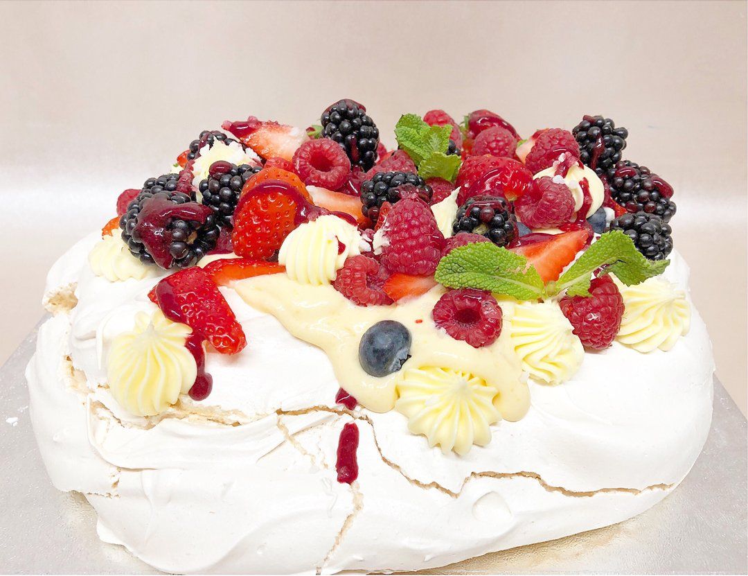 A white cake with berries on top of it