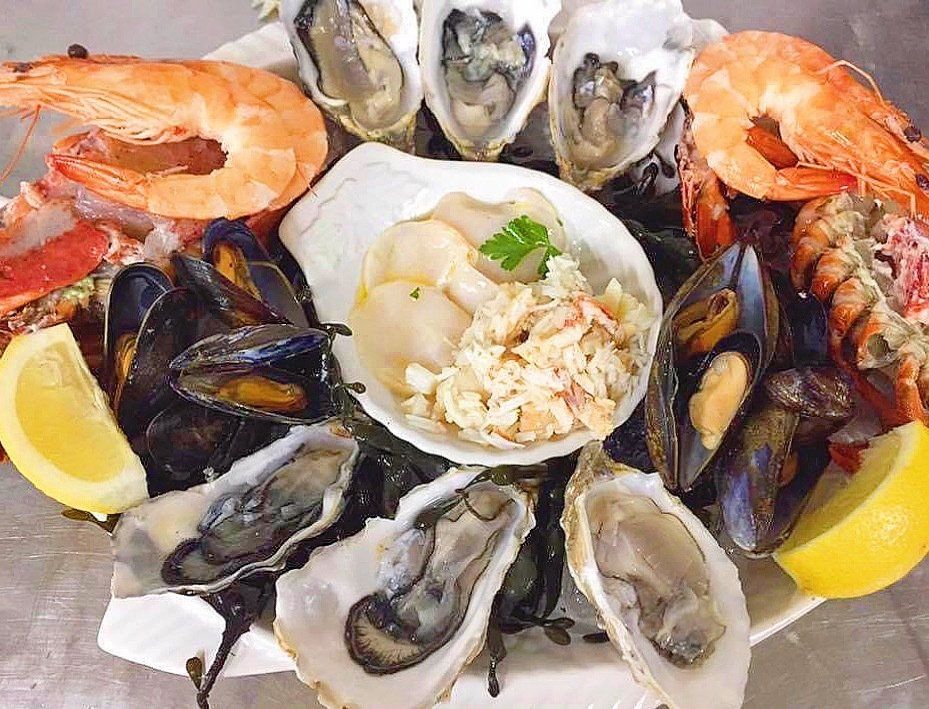 A white plate topped with noodles asparagus and tomatoes