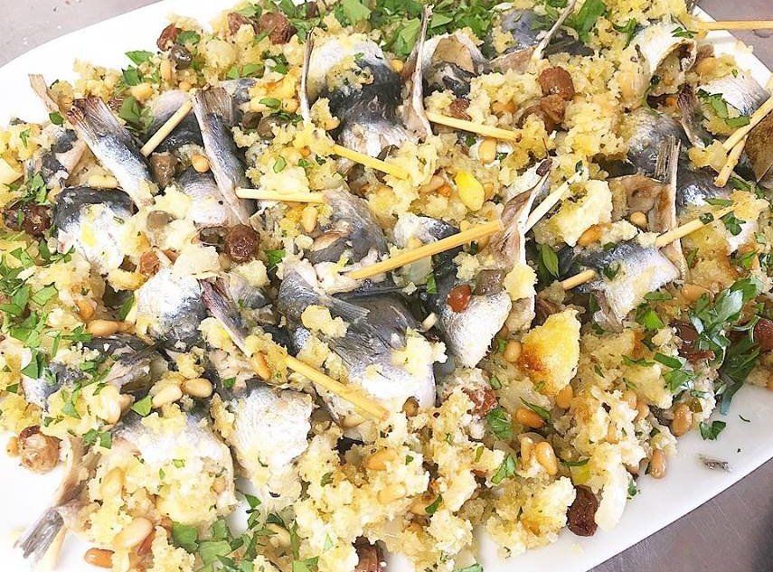 A white plate topped with rice and fish on a table.