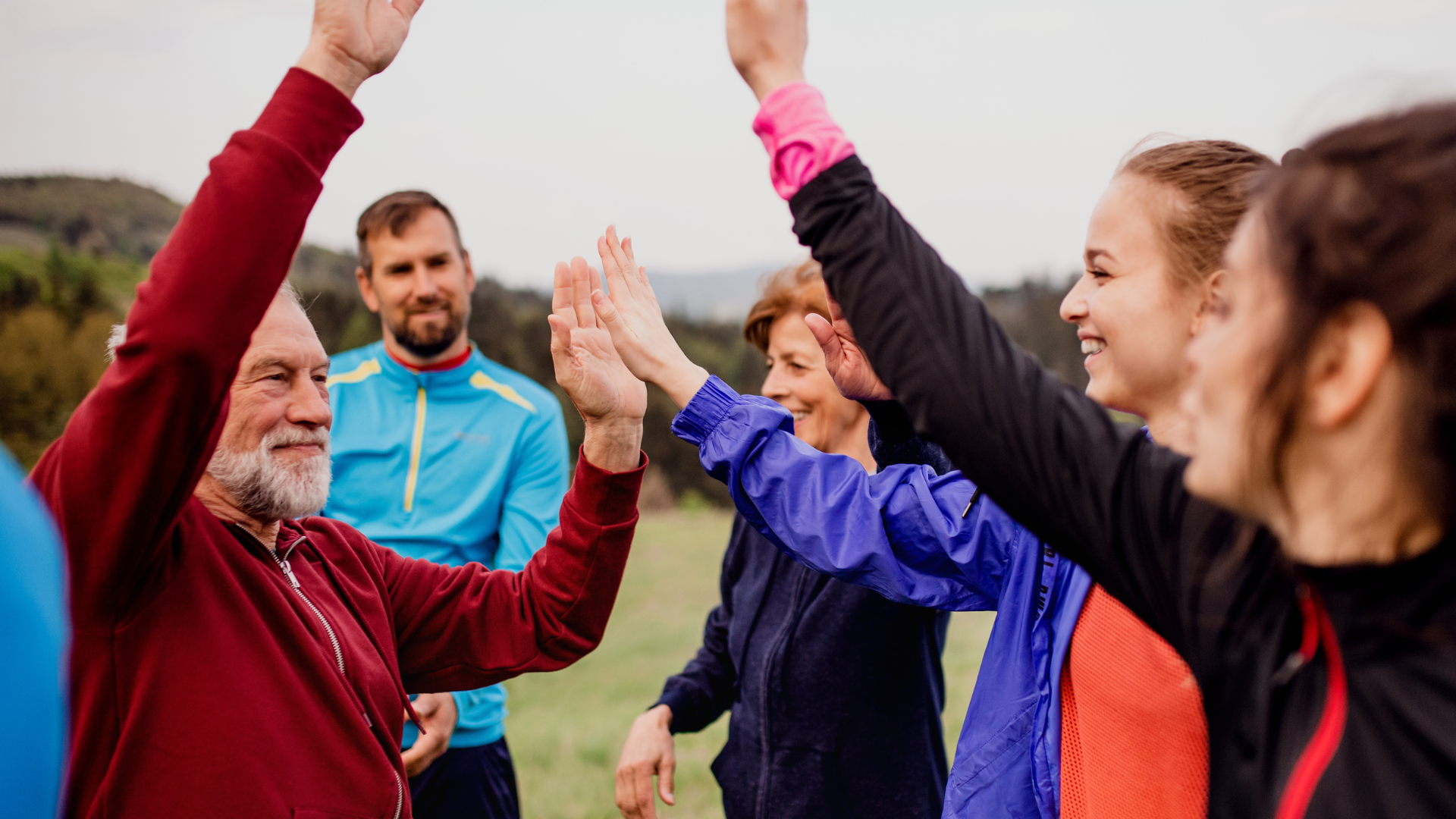 A group of people are giving each other a high five.