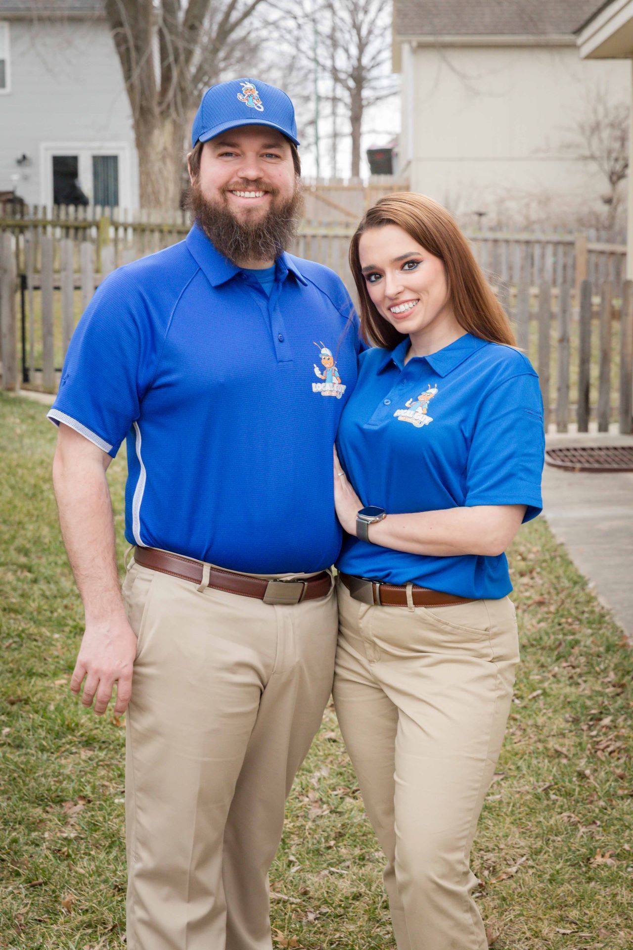 A man and a woman are standing next to each other in a yard.
