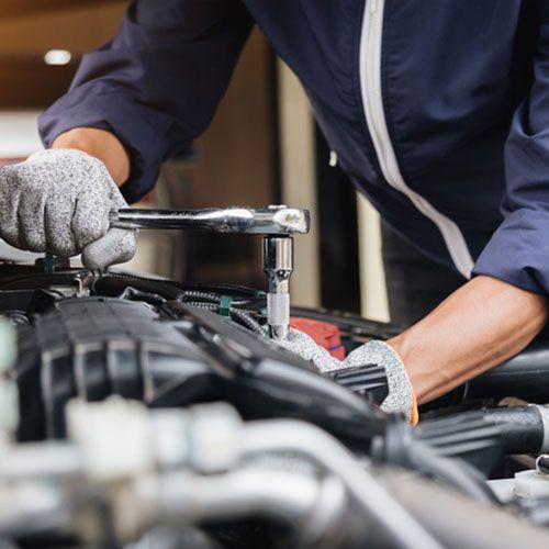 Automobile mechanic repairman hands repairing a car engine automotive workshop with a wrench, car service and maintenance, Repair service.