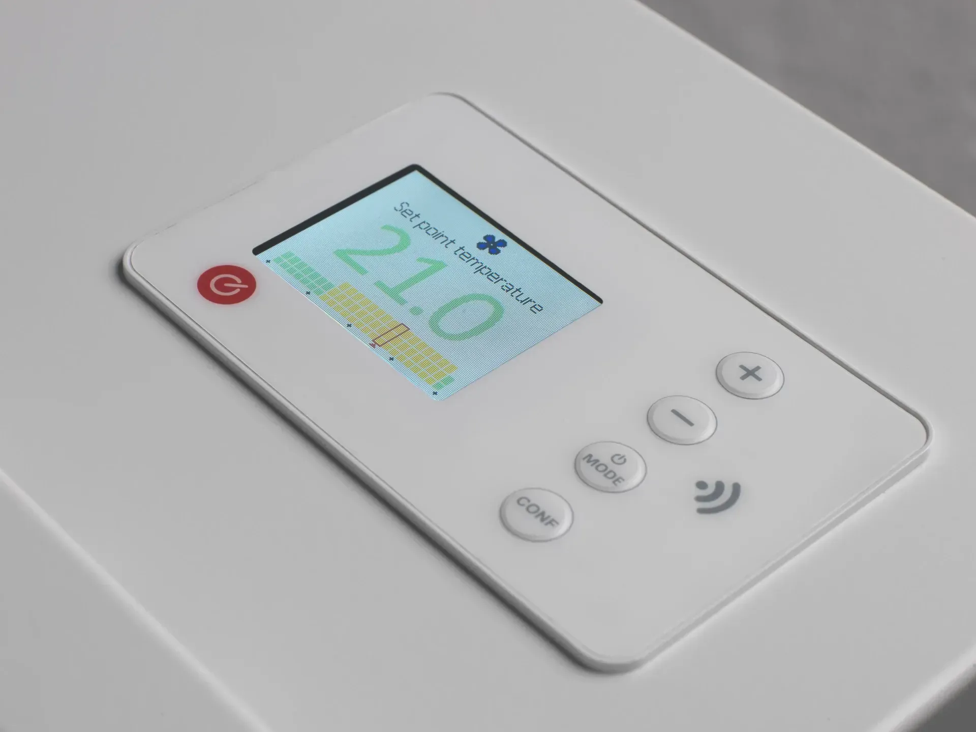 White thermostat with digital display showing 21.0 degrees. Buttons for control and a wireless symbol.