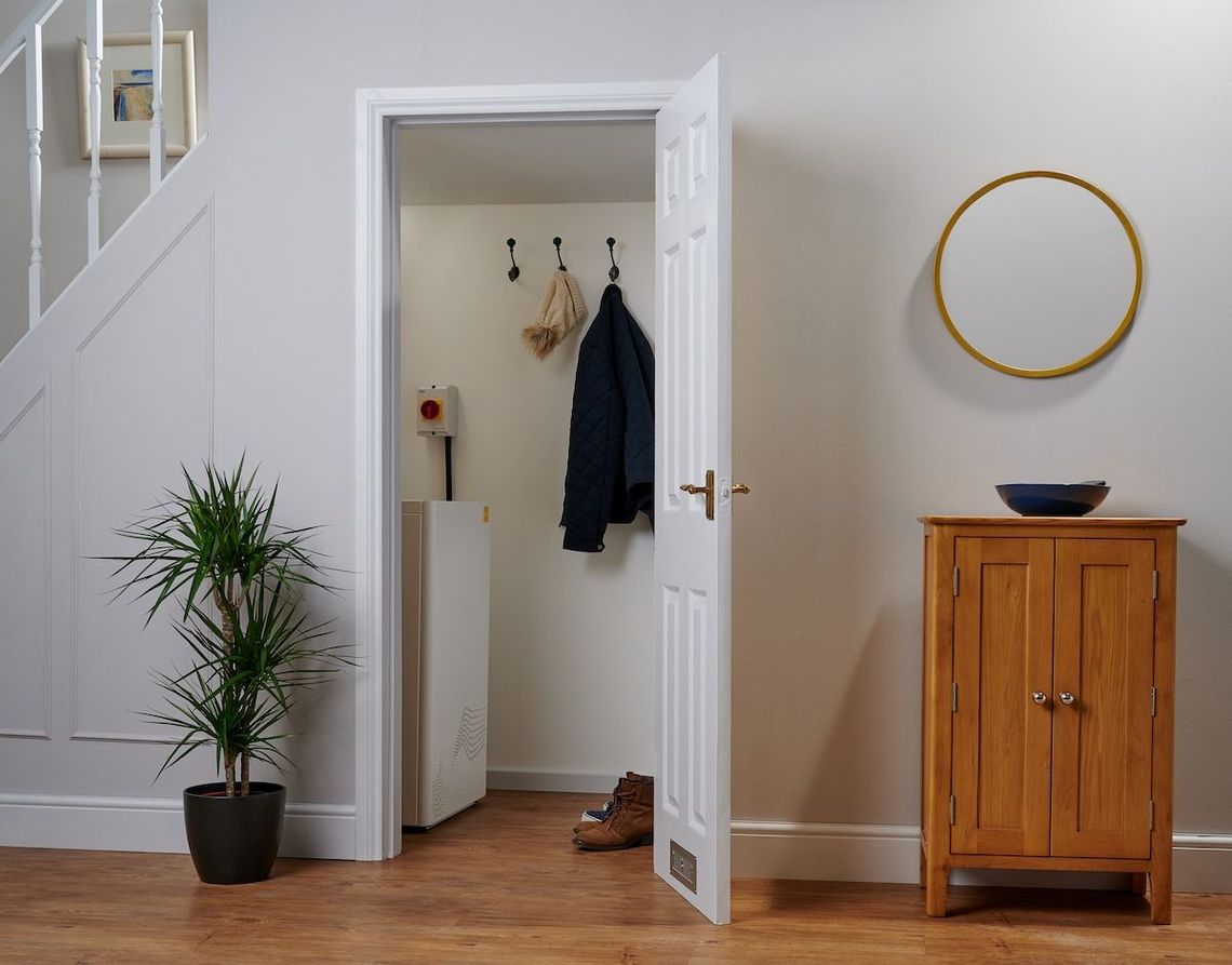 A hallway with a door open to a closet