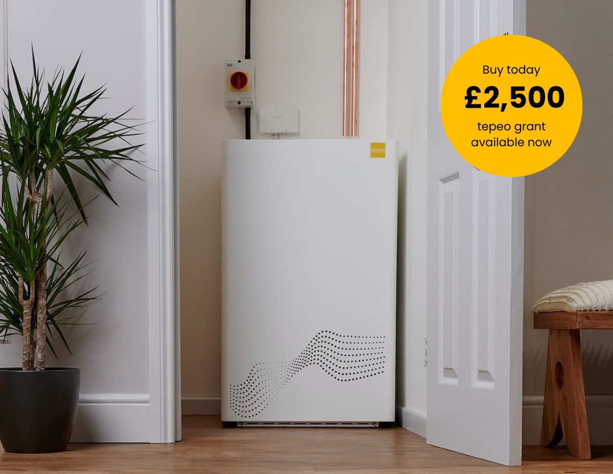 A person is adjusting a thermostat on a radiator.