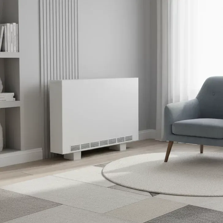 White storage heater in a modern living room setting with a grey armchair and a round rug.