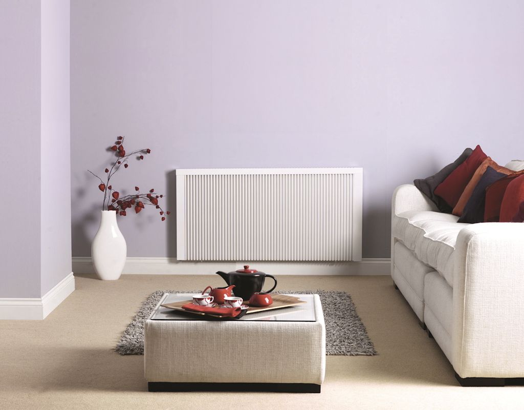 A living room with a white couch and a white radiator
