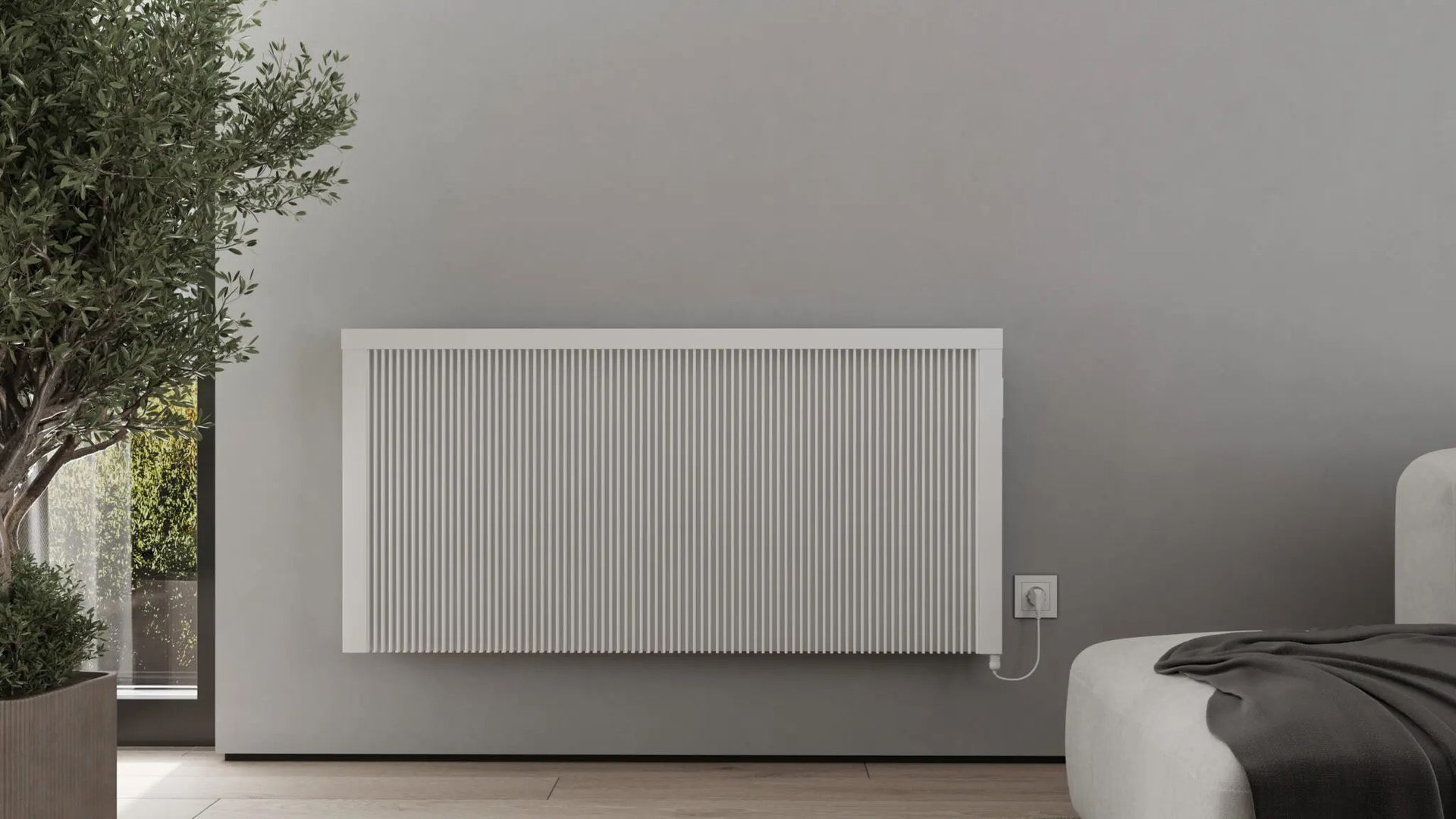 A white radiator is hanging on a wall in a living room next to a couch.