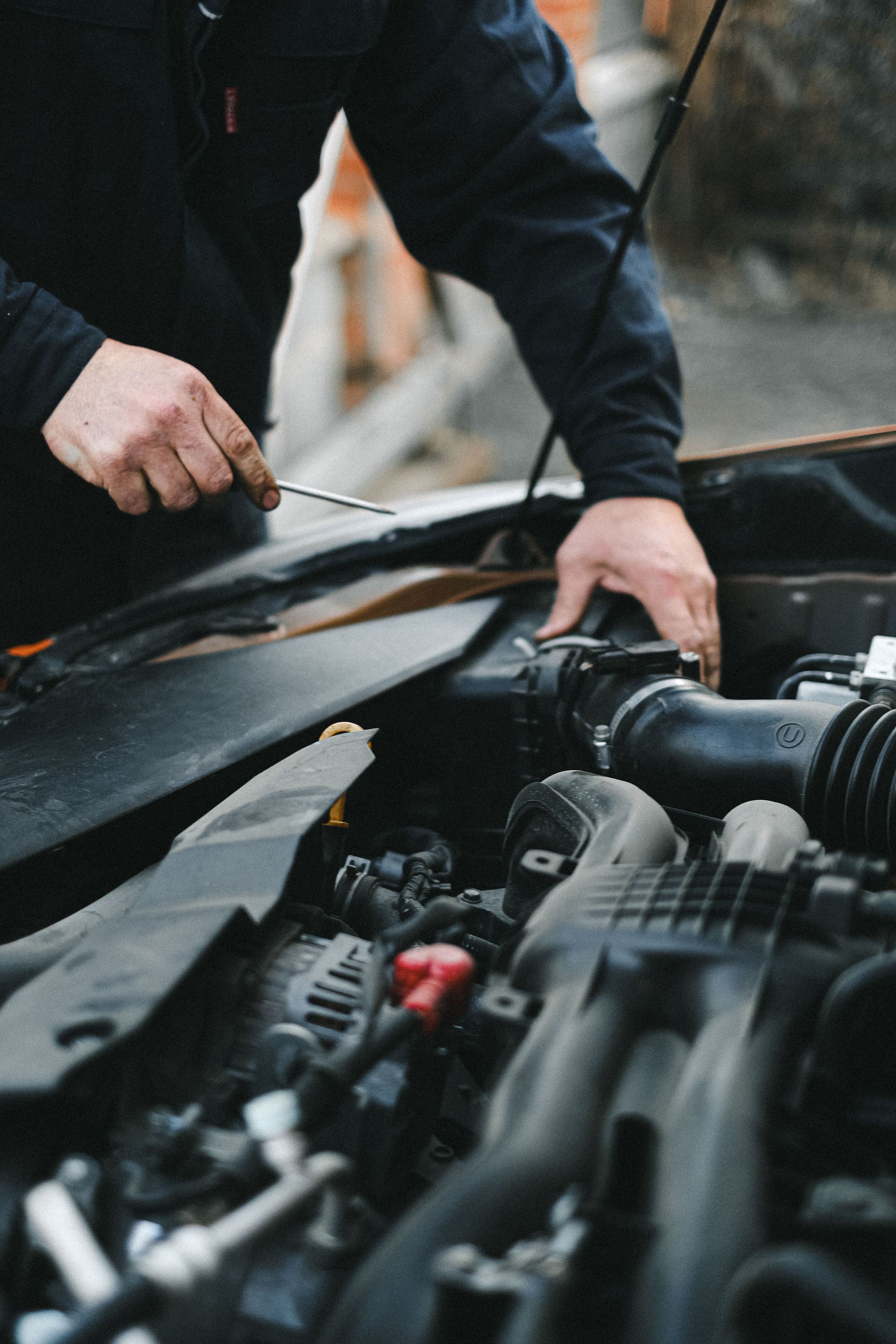Mechanic Checking Vehicle Engine Bay | Knost Tire & Automotive