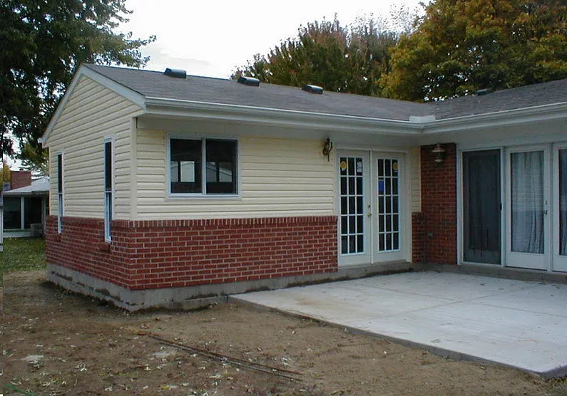 Renovate208.com: A house with a screened in porch and brick siding