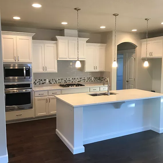 Renovate208.com: A kitchen with white cabinets , stainless steel appliances , and a large island.