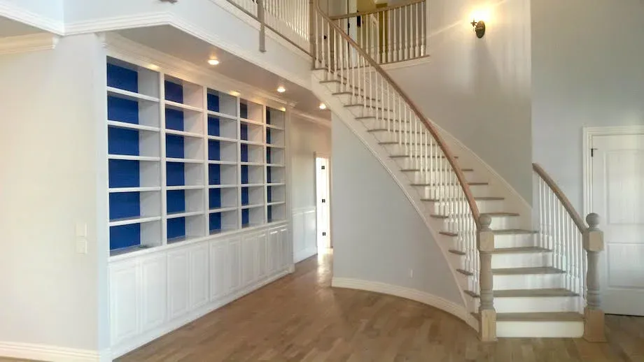Renovate208.com: A curved staircase in an empty room with shelves