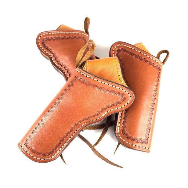 Three brown leather pistol holsters.