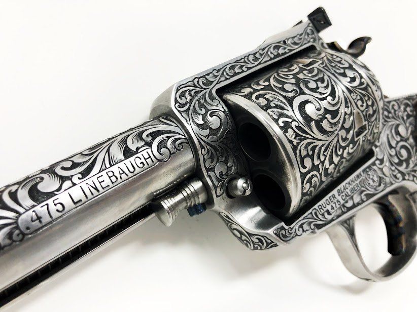 Engraved silver revolver with floral scrollwork, 
