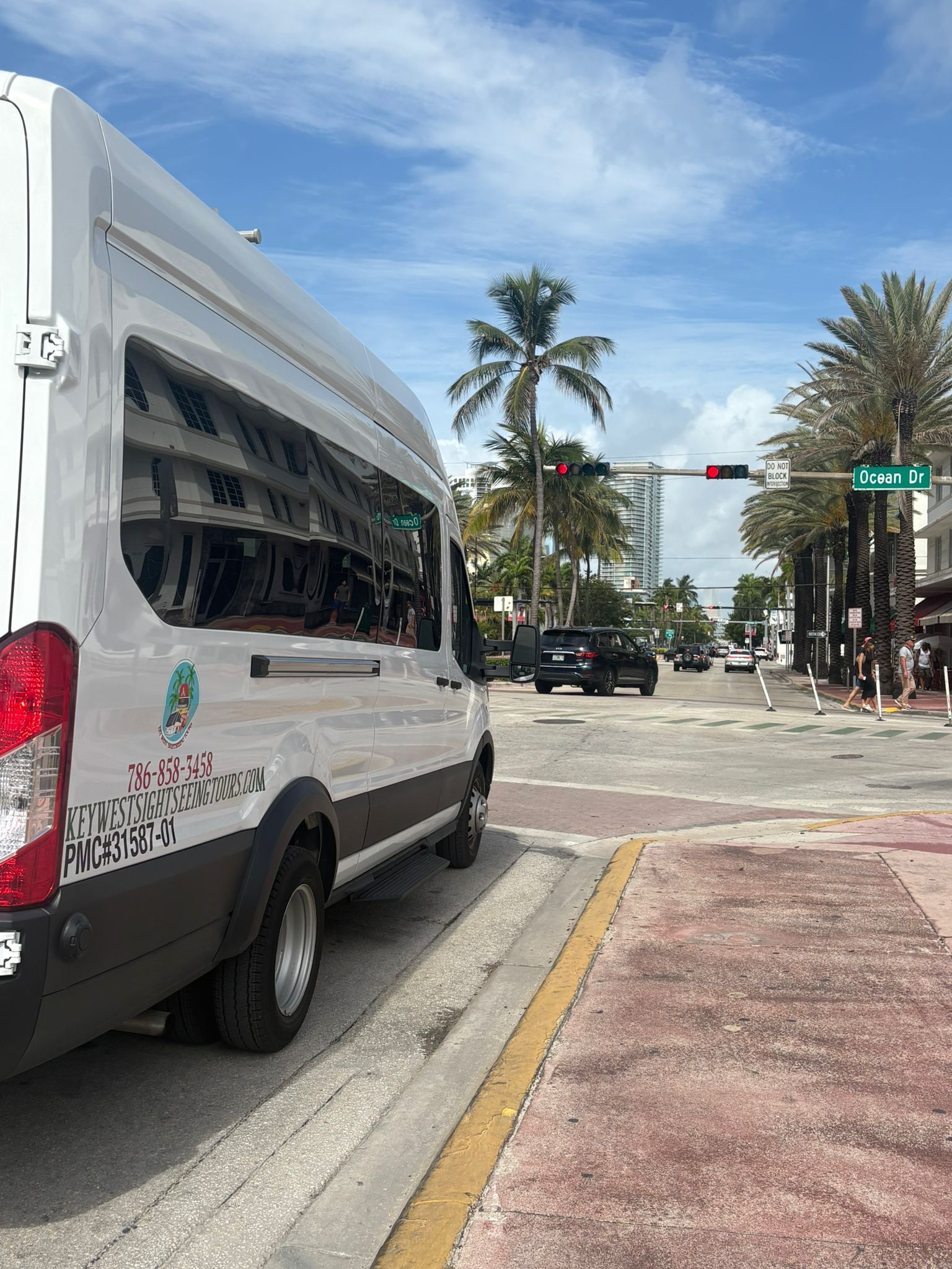 Air-conditioned mini bus used for small group Miami City Bus Tours parked near Ocean Drive
