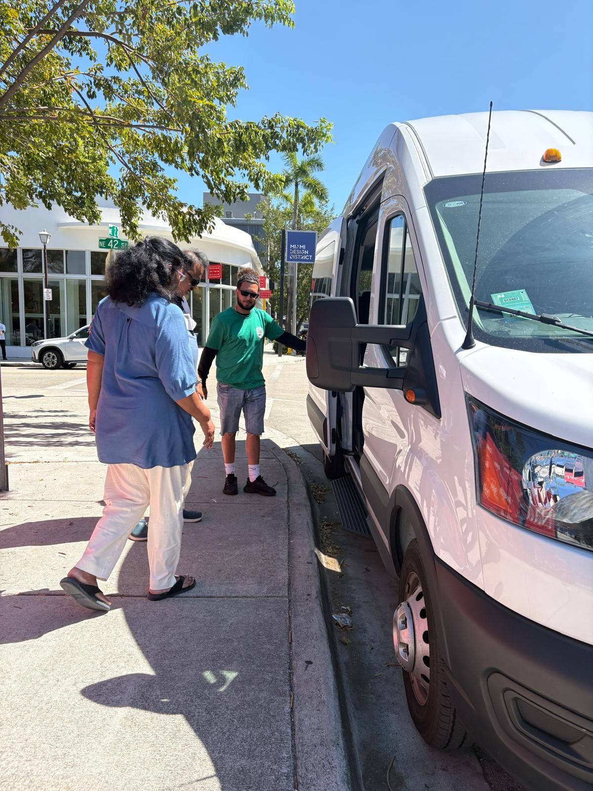Guests boarding a comfortable air-conditioned mini bus for their Hop on Hop off Miami sightseeing Bus Tour experience
