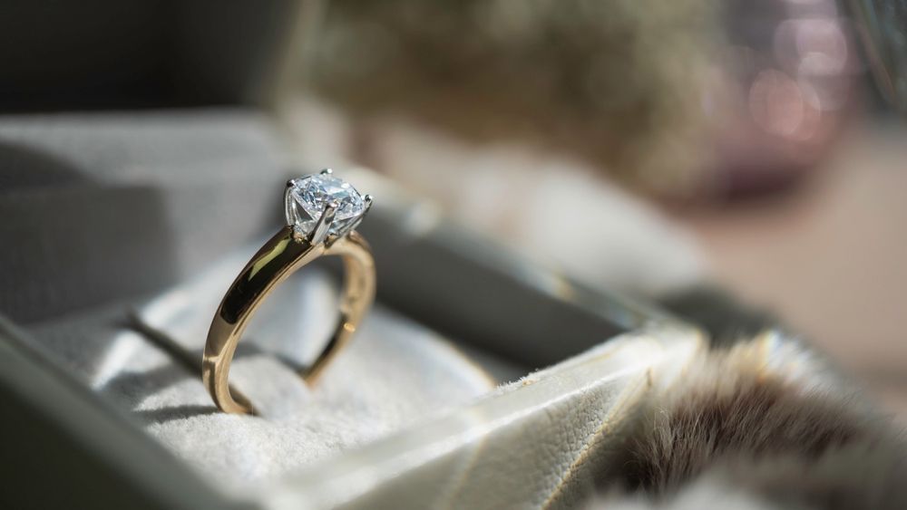 Three Silver Rings With Diamonds, Stacked on a Textured, Dark Surface — Regency Jewellers in Cairns City, QLD
