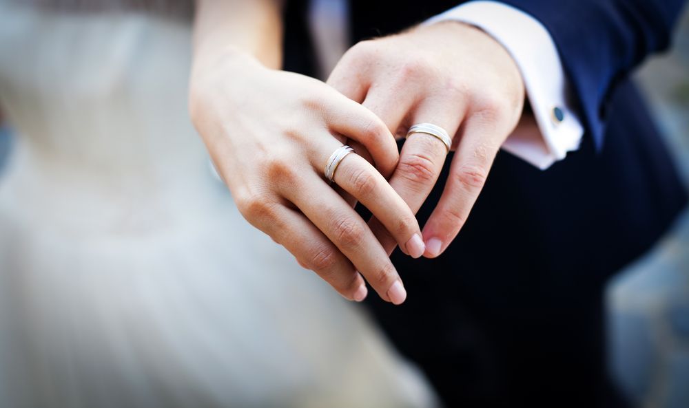 Close-up of Hands With Wedding Rings Clasped Together — Regency Jewellers in Cairns City, QLD