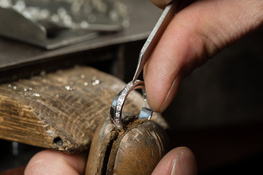 Jeweler Using a Tool to Set Small Diamonds on a Ring — Regency Jewellers in Cairns City, QLD